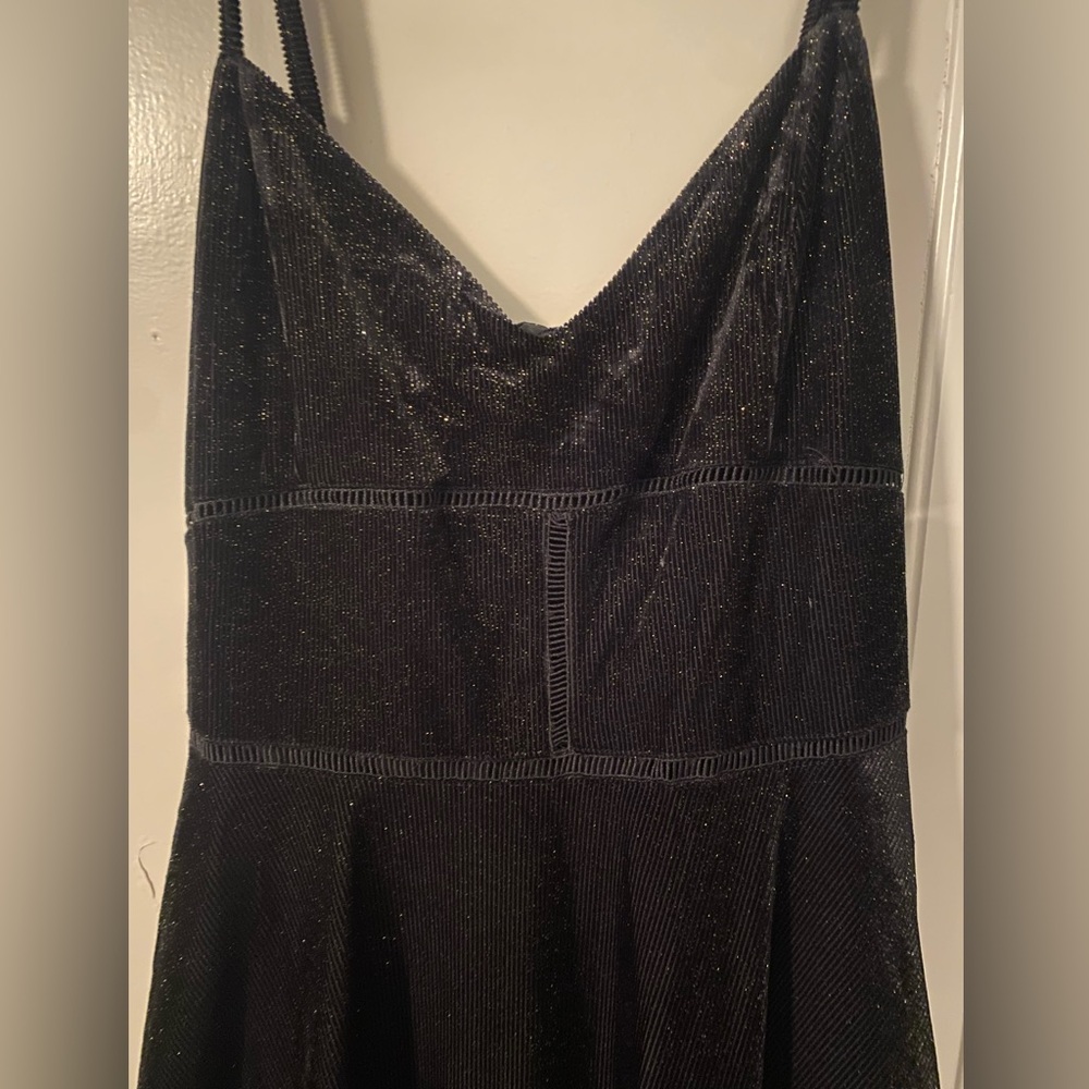Black cocktail. Bought for homecoming- never wore. Size Large.